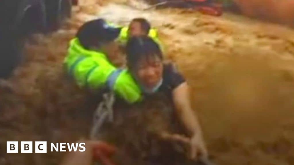 The moment a woman was saved from rushing flood waters in China